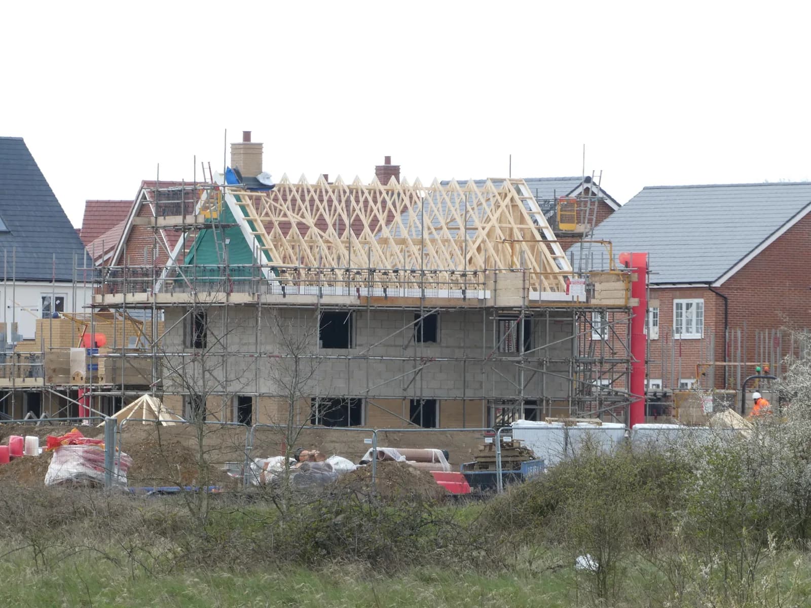 New house under construction with timber framing and scaffolding