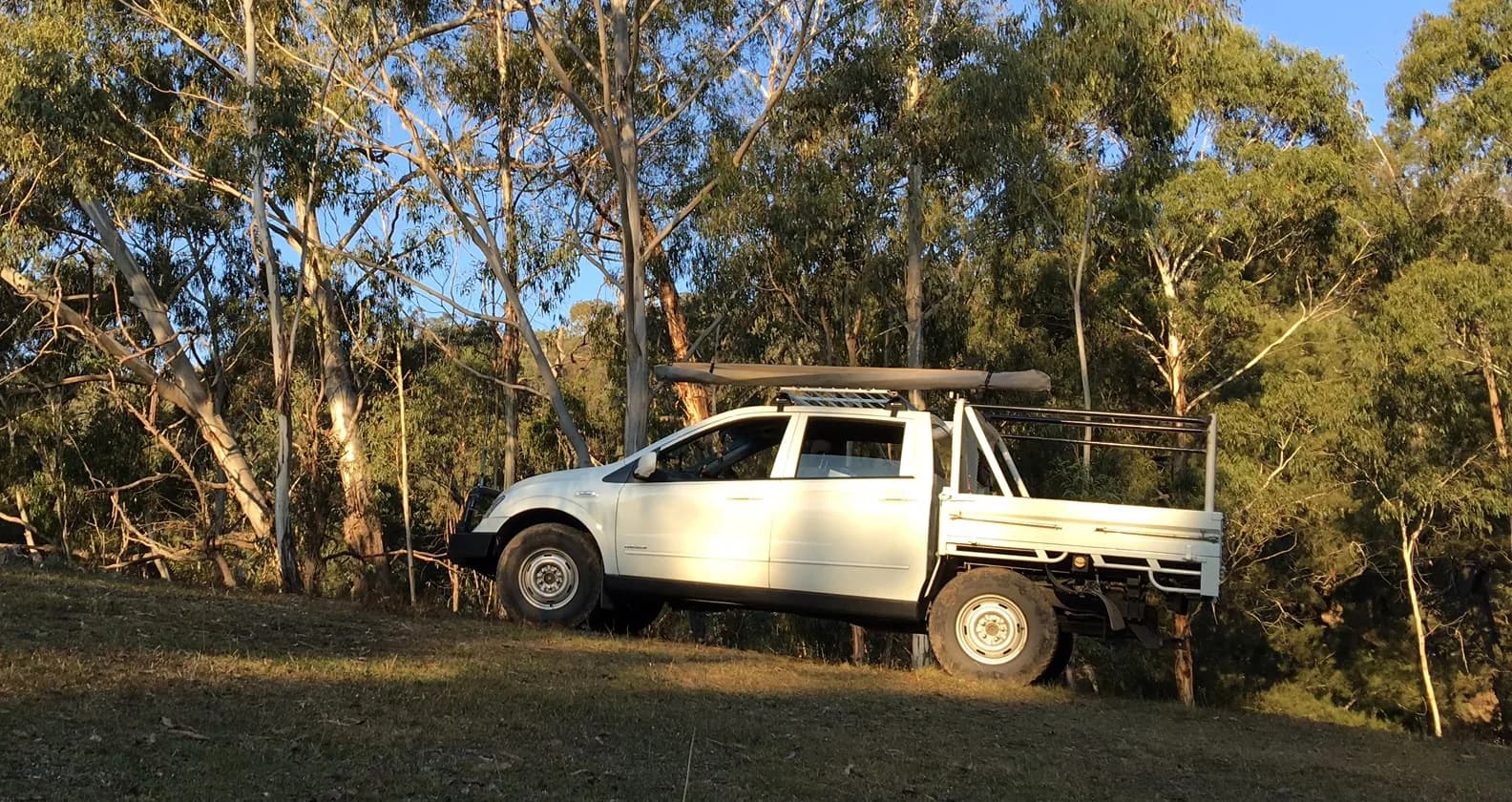 Tradie ute parked with tray and toolboxes