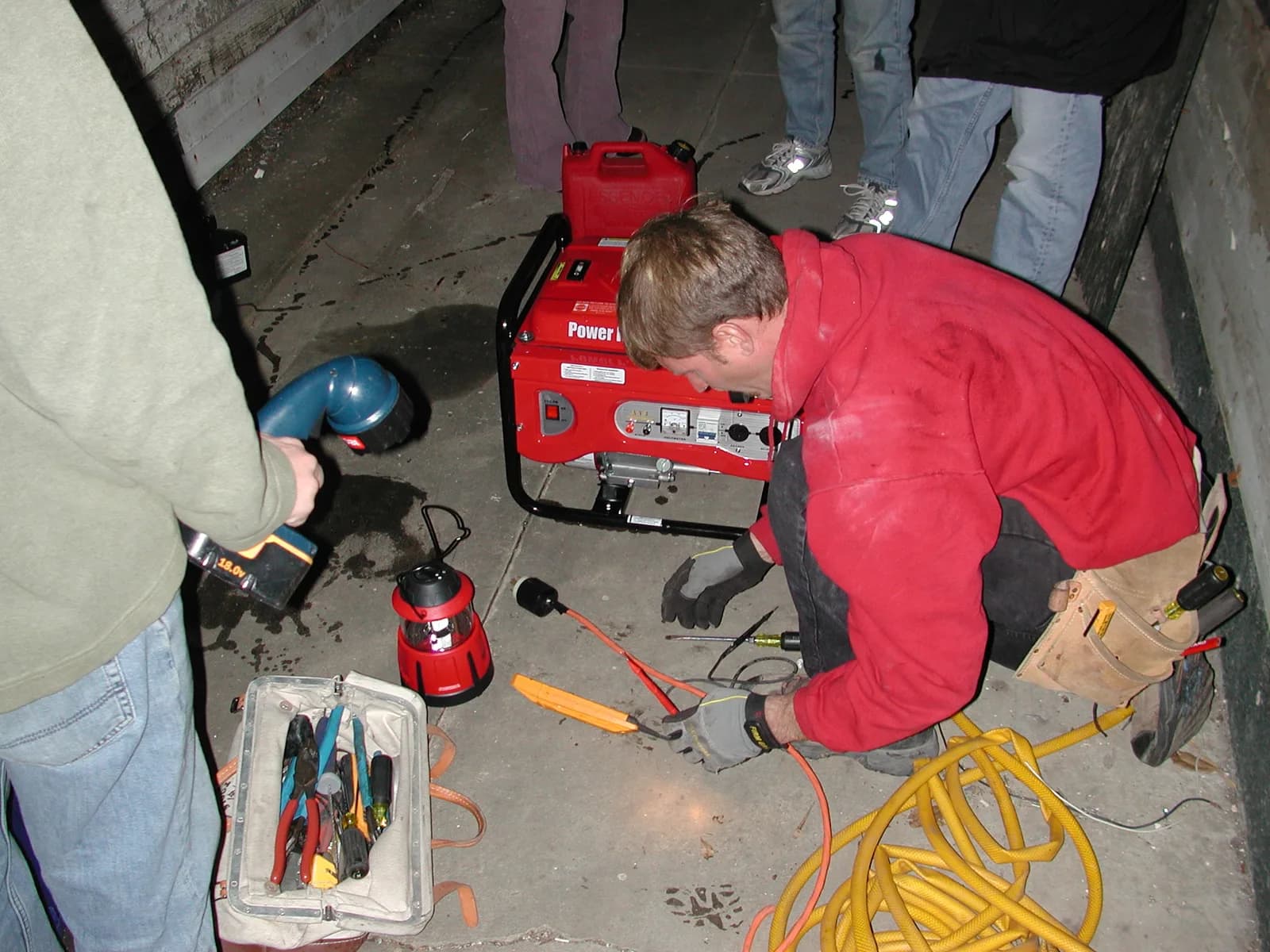 Tradesman working overhead on an electrical installation