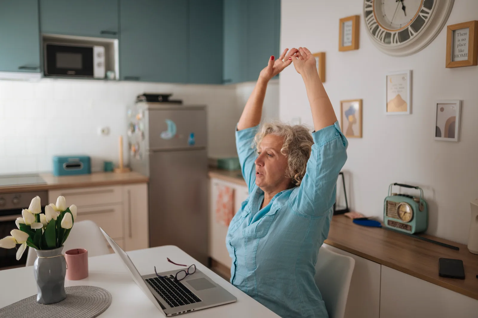 Business owner working on a laptop at a home office desk